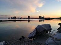 Sunset with dinghy on the swim platform davits at home dock in Toronto, Canada.