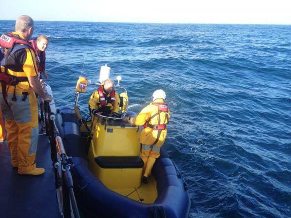 Taking on Chas from St Davids lifeboat for run back to Milford Haven (photo credit St Davids RNLI)